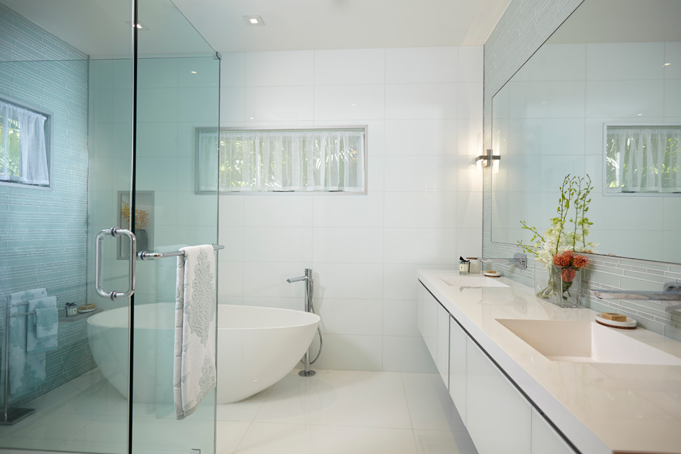 Bathroom - mid-sized contemporary master white tile and stone tile marble floor bathroom idea in Miami with furniture-like cabinets, white cabinets, a one-piece toilet, white walls, a pedestal sink and glass countertops