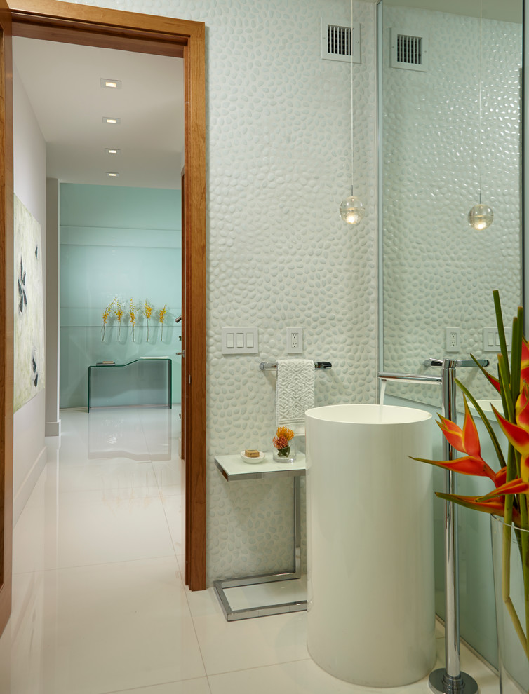 Design ideas for a medium sized contemporary ensuite bathroom in Miami with freestanding cabinets, white cabinets, a freestanding bath, a double shower, a one-piece toilet, white tiles, stone tiles, white walls, marble flooring, a pedestal sink and glass worktops.