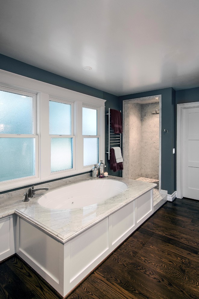 This is an example of a medium sized classic ensuite bathroom in Los Angeles with a submerged sink, shaker cabinets, white cabinets, marble worktops, a corner shower, beige tiles, ceramic tiles, green walls and medium hardwood flooring.