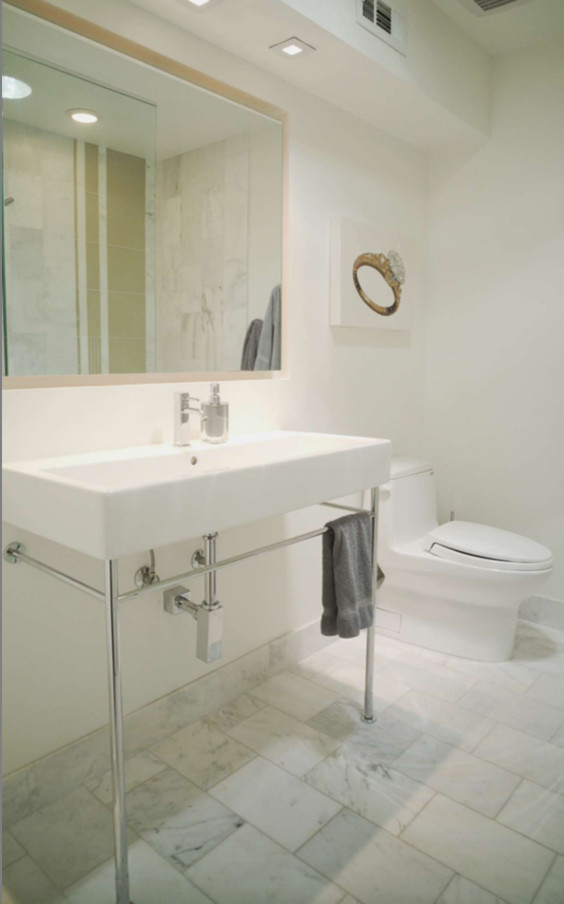 Photo of a small contemporary shower room bathroom in Phoenix with white cabinets, a walk-in shower, a one-piece toilet, white tiles, marble tiles, white walls, marble flooring, a pedestal sink, solid surface worktops, white floors, an open shower, freestanding cabinets and white worktops.