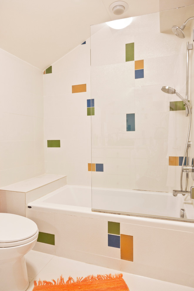 Photo of a modern family bathroom in Chicago with an alcove bath, a one-piece toilet, multi-coloured tiles, metro tiles and multi-coloured walls.