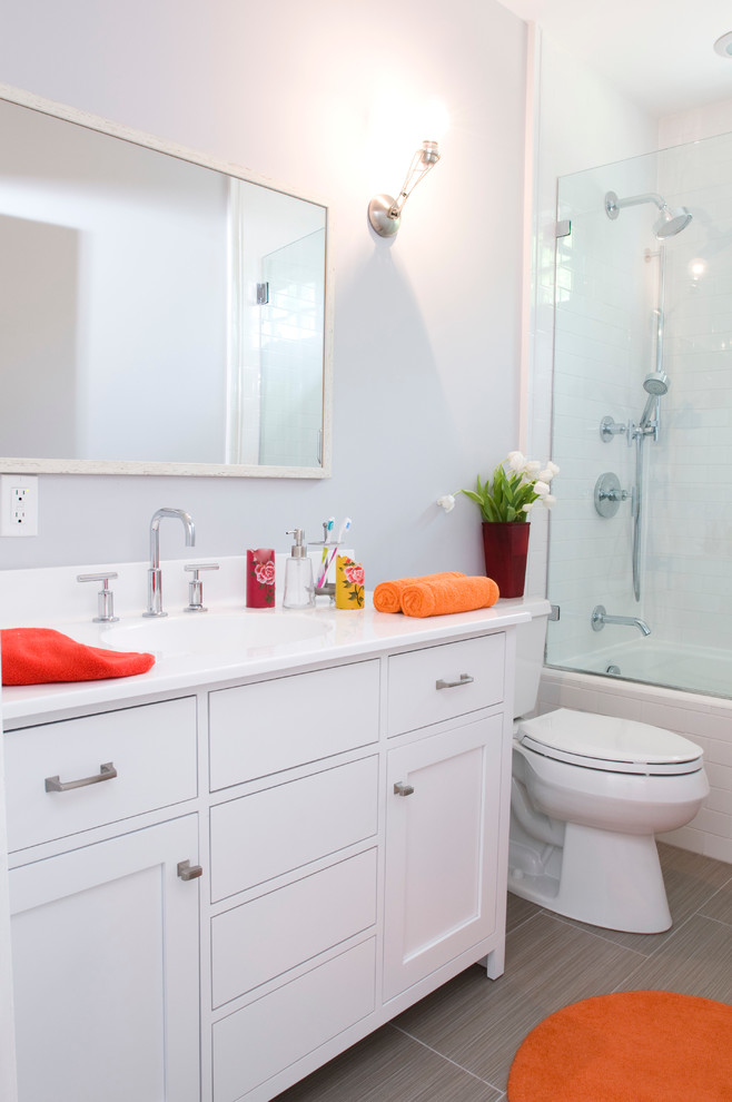Inspiration for a mid-sized contemporary kids' white tile and subway tile porcelain tile bathroom remodel in New York with an undermount sink, recessed-panel cabinets, white cabinets, a one-piece toilet, gray walls and quartz countertops