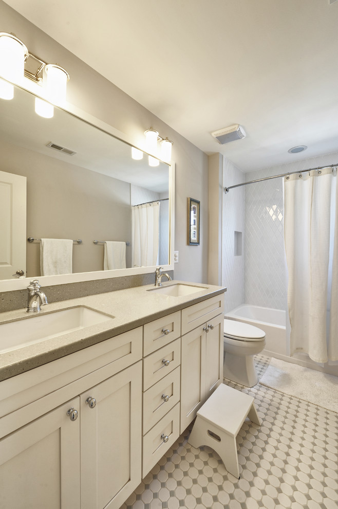 Elegant white tile bathroom photo in Philadelphia with an undermount sink, shaker cabinets and white cabinets