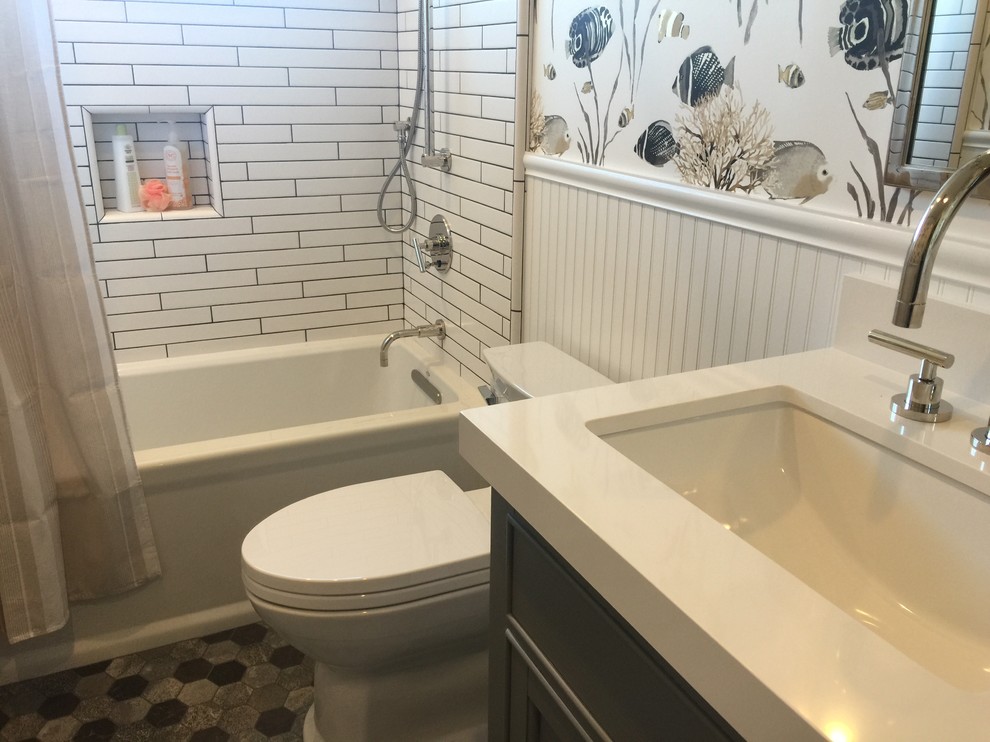 Medium sized nautical family bathroom in San Francisco with recessed-panel cabinets, grey cabinets, an alcove bath, a shower/bath combination, a one-piece toilet, white tiles, multi-coloured walls, a submerged sink, solid surface worktops, multi-coloured floors, a shower curtain, white worktops, metro tiles, marble flooring, a wall niche, double sinks, a built in vanity unit and wallpapered walls.