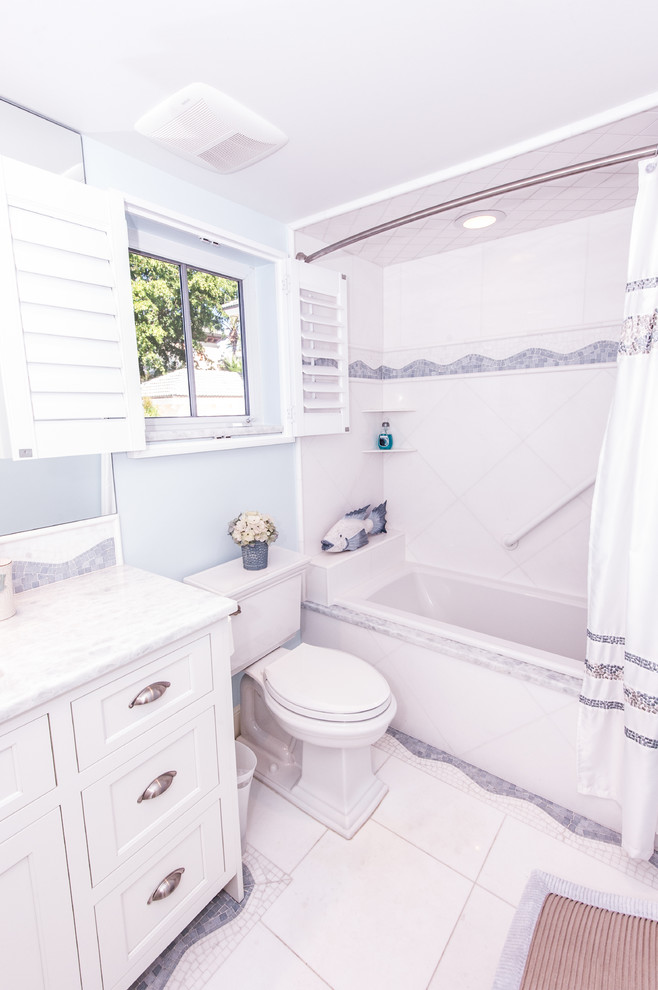 Bathroom - mid-sized coastal 3/4 blue tile, gray tile and white tile bathroom idea in Miami with shaker cabinets, white cabinets, a two-piece toilet, blue walls, an undermount sink and marble countertops