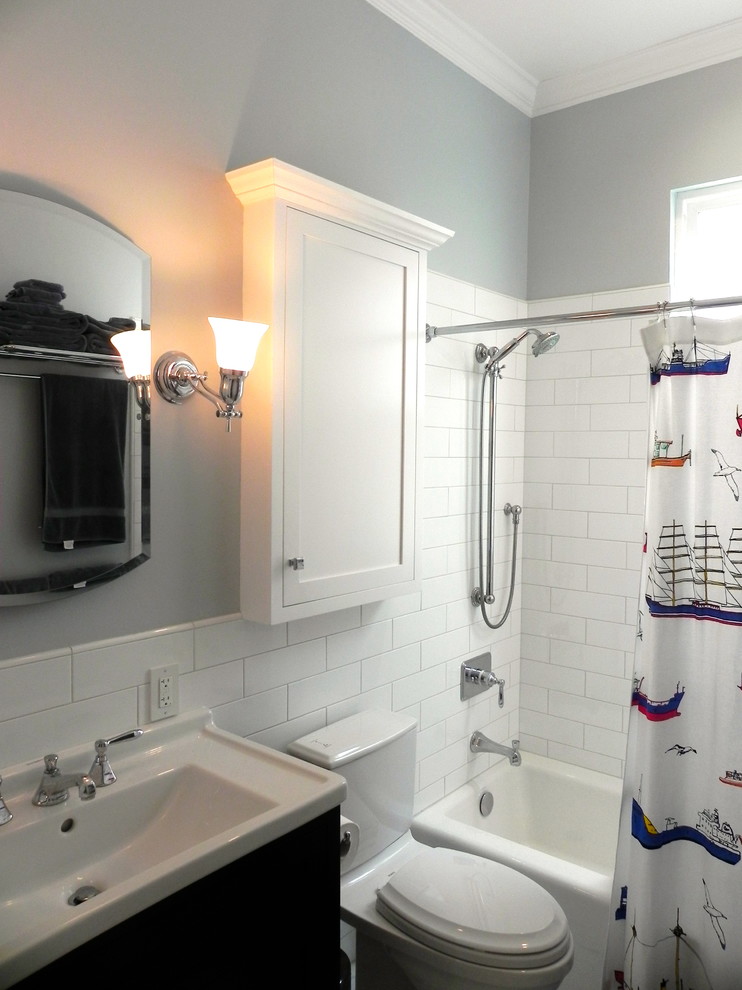 Example of a mid-sized classic kids' white tile and ceramic tile marble floor bathroom design in San Francisco with furniture-like cabinets, medium tone wood cabinets, a two-piece toilet, blue walls, an integrated sink and solid surface countertops