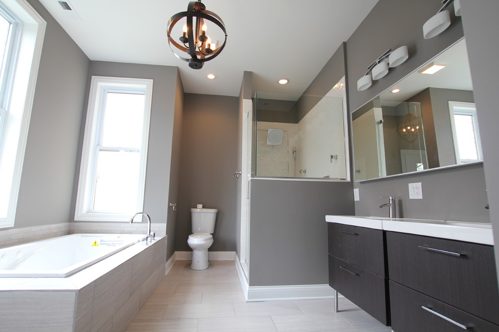 Inspiration for a large modern master gray tile and porcelain tile porcelain tile bathroom remodel in Chicago with an integrated sink, flat-panel cabinets, dark wood cabinets, a two-piece toilet and gray walls