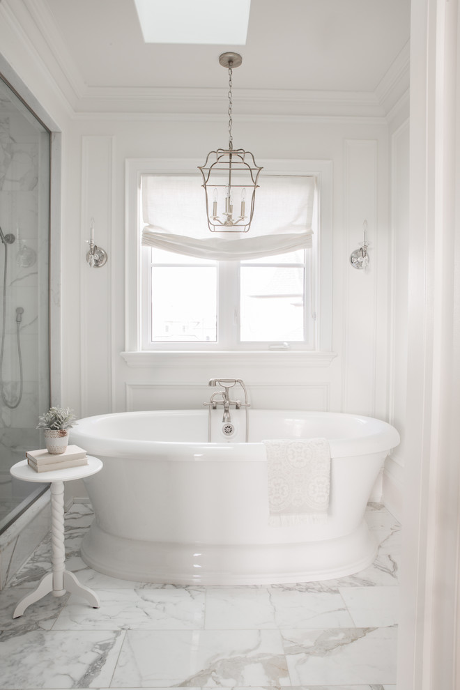 Freestanding bathtub - traditional white tile white floor freestanding bathtub idea in Toronto with white walls