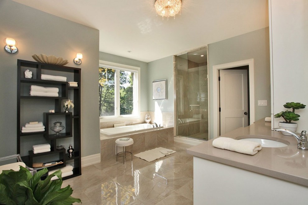 Large traditional ensuite bathroom in Toronto with shaker cabinets, white cabinets, engineered stone worktops, beige tiles, a built-in bath, an alcove shower, grey walls, marble flooring, a submerged sink, beige floors and a hinged door.