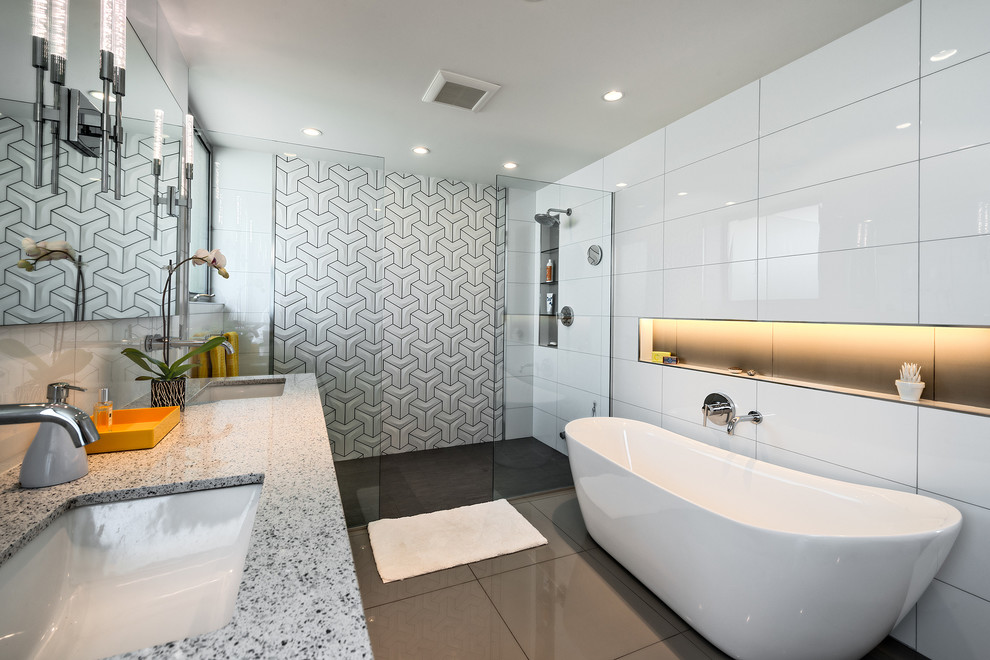 Design ideas for a large contemporary ensuite bathroom in Los Angeles with a wall-mounted sink, flat-panel cabinets, white cabinets, quartz worktops, a freestanding bath, a built-in shower, a wall mounted toilet, white tiles, white walls and porcelain flooring.