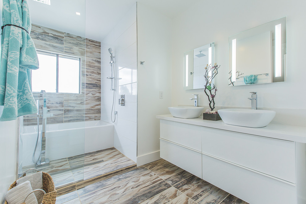 Example of a mid-sized minimalist brown tile and porcelain tile porcelain tile bathroom design in Los Angeles with a vessel sink, flat-panel cabinets, white cabinets, quartz countertops, a two-piece toilet and white walls