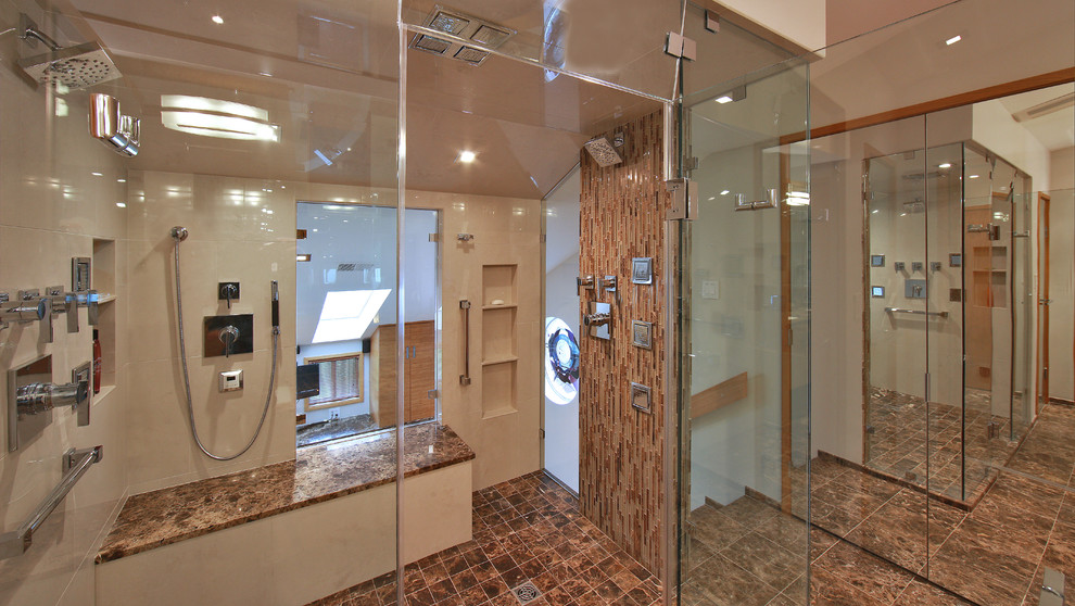 This is an example of a contemporary bathroom in DC Metro with a submerged sink, flat-panel cabinets, medium wood cabinets, marble worktops, a corner bath, a double shower, a one-piece toilet, brown tiles and stone tiles.