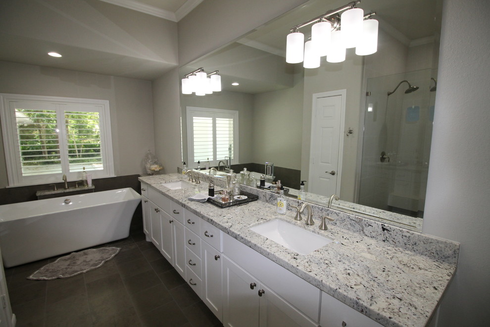 Bathroom - traditional master gray tile and stone tile porcelain tile bathroom idea in Houston with an undermount sink, shaker cabinets, white cabinets, granite countertops and multicolored walls