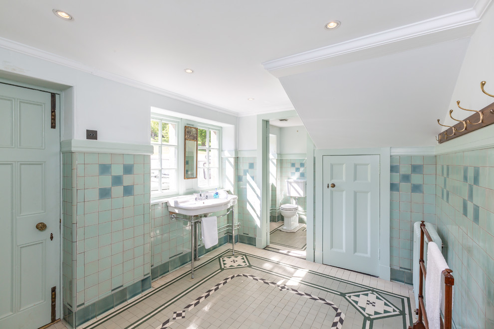 Classic bathroom in Other with blue tiles, white walls, a console sink, multi-coloured floors and white worktops.