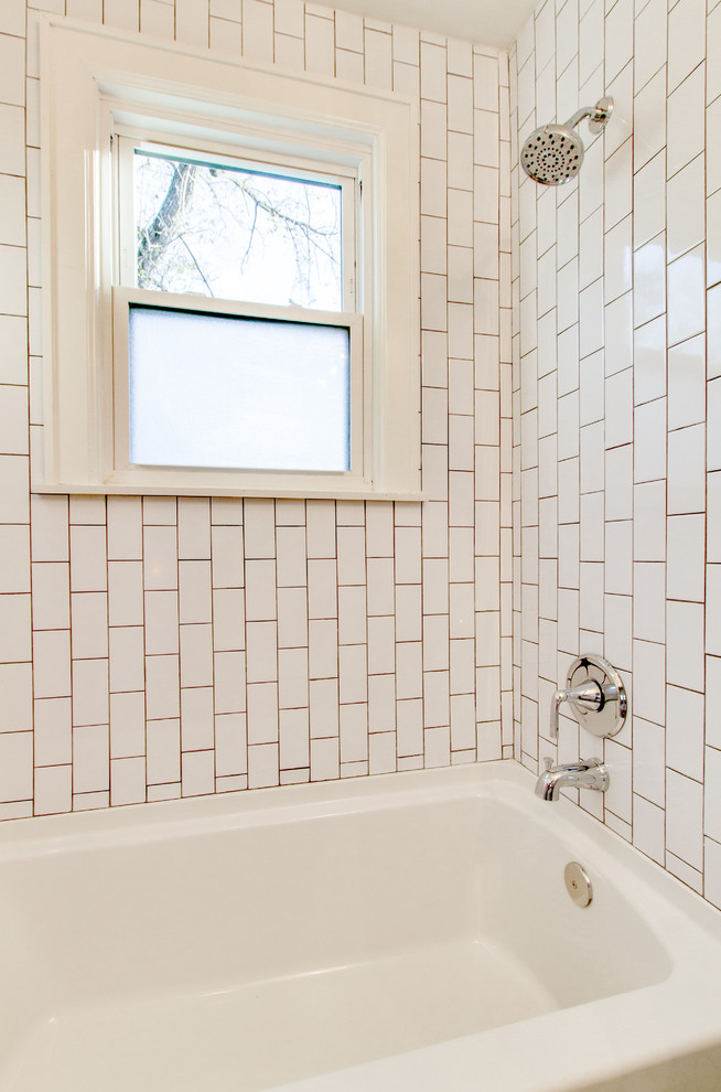 Medium sized modern bathroom in Nashville with flat-panel cabinets, brown cabinets, an alcove bath, a shower/bath combination, a one-piece toilet, white tiles, ceramic tiles, white walls, marble flooring, a vessel sink, grey floors and a shower curtain.