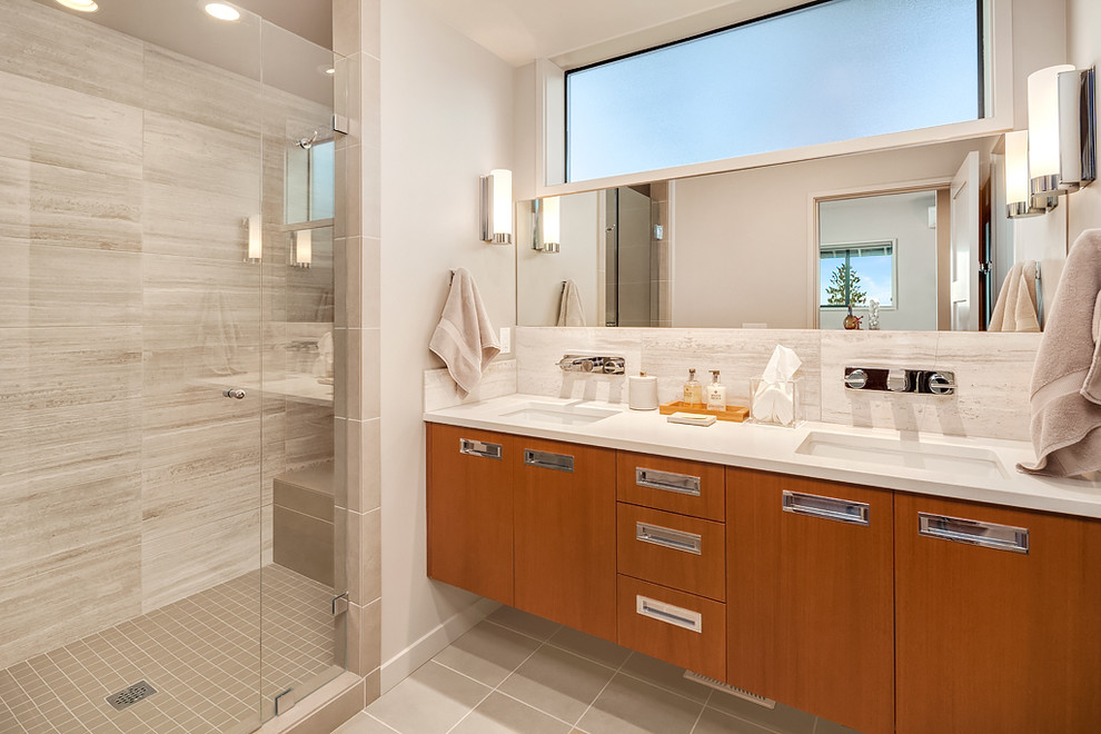 Inspiration for a medium sized contemporary shower room bathroom in Seattle with flat-panel cabinets, medium wood cabinets, a walk-in shower, grey tiles, porcelain tiles, grey walls, porcelain flooring, a submerged sink and engineered stone worktops.
