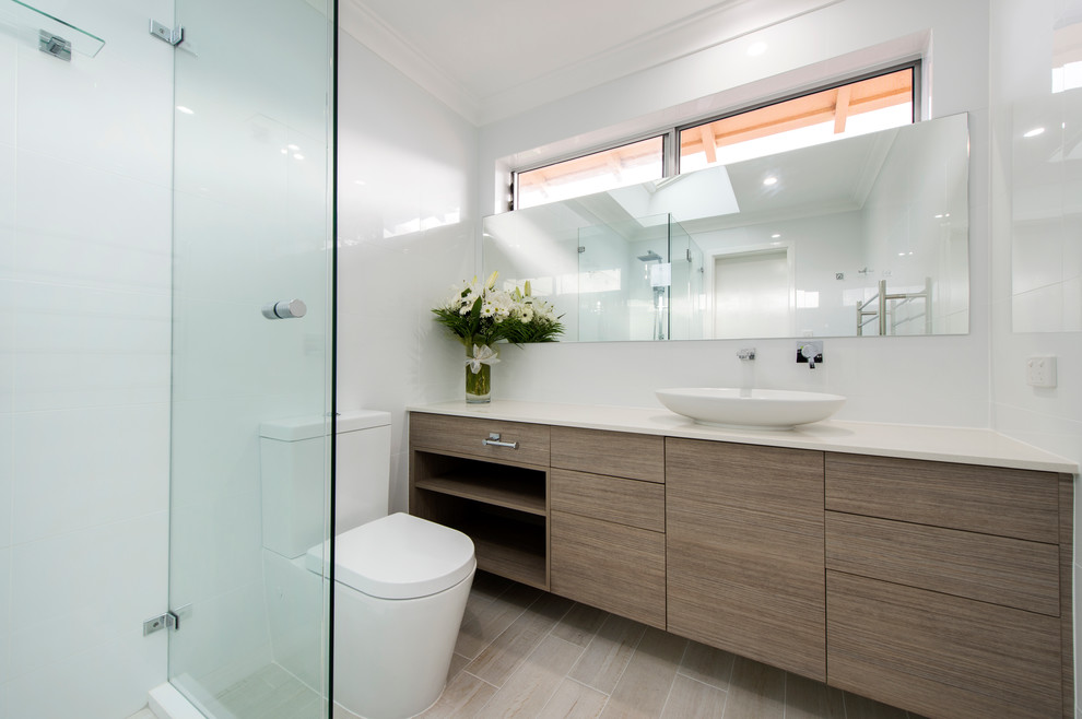 Photo of a medium sized contemporary ensuite bathroom in Perth with a vessel sink, beaded cabinets, dark wood cabinets, engineered stone worktops, a built-in shower, a two-piece toilet, black tiles, porcelain tiles, white walls and porcelain flooring.
