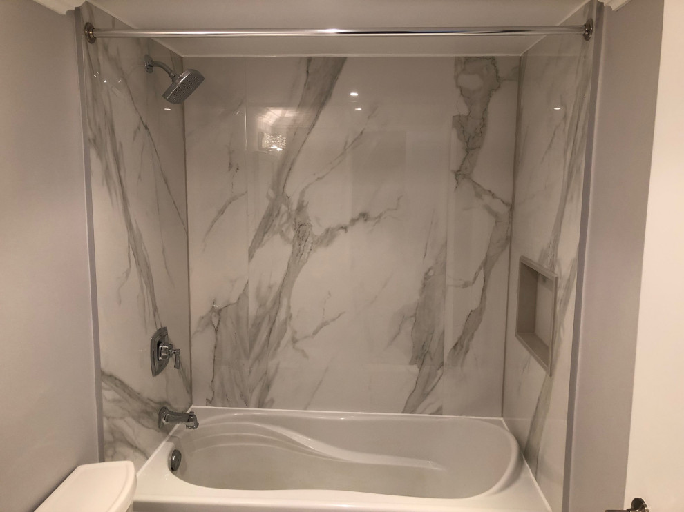 Photo of a medium sized traditional shower room bathroom in Toronto with raised-panel cabinets, white cabinets, an alcove bath, a shower/bath combination, grey tiles, marble tiles, grey walls, marble flooring, a submerged sink, granite worktops, multi-coloured floors and grey worktops.