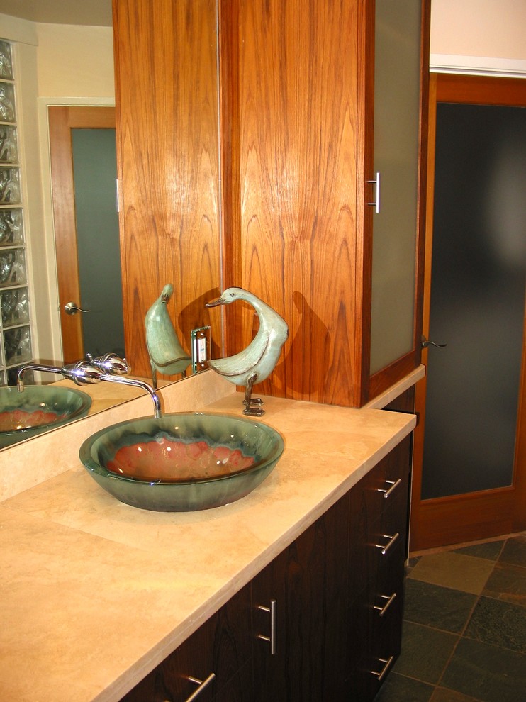 Example of a mid-sized trendy master slate floor bathroom design in Los Angeles with a vessel sink, glass-front cabinets and medium tone wood cabinets