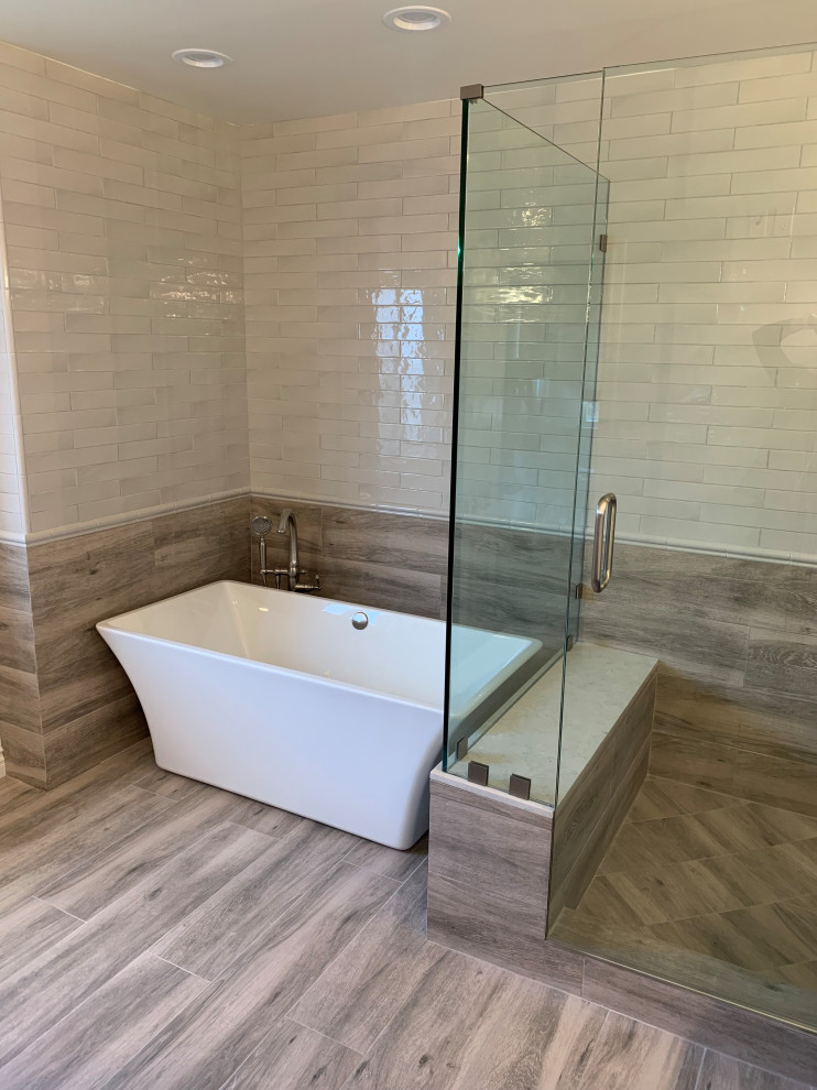 Example of a large classic master white tile and porcelain tile porcelain tile and beige floor bathroom design in Orange County with shaker cabinets, gray cabinets, a two-piece toilet, white walls, an undermount sink, quartzite countertops, a hinged shower door and white countertops