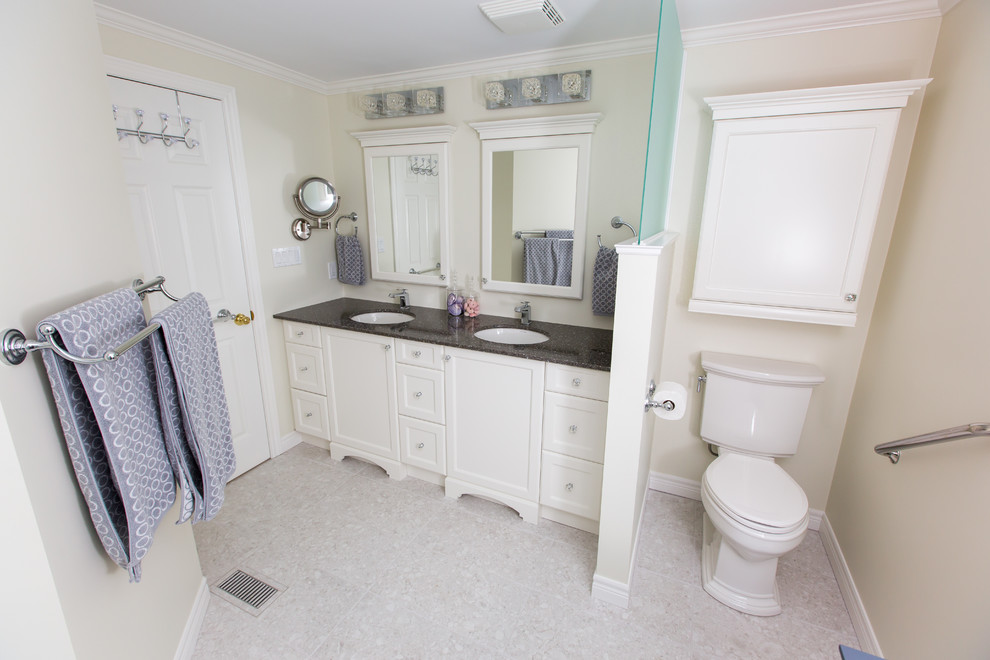 Photo of a medium sized traditional ensuite bathroom in Toronto with a submerged sink, shaker cabinets, white cabinets, engineered stone worktops, an alcove shower, a two-piece toilet, white tiles, ceramic tiles, beige walls and porcelain flooring.