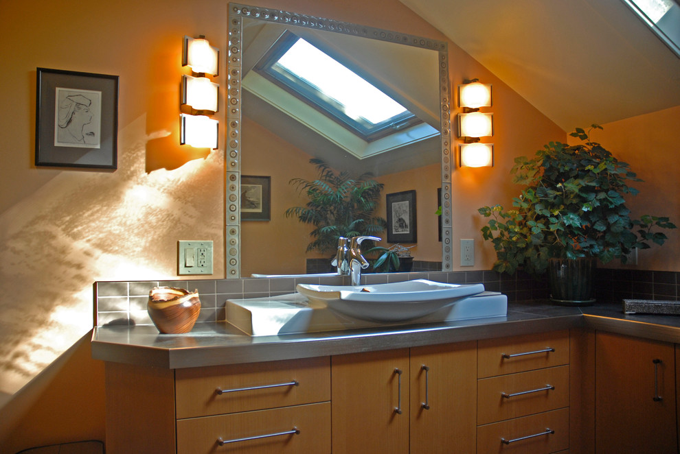 This is an example of a traditional ensuite bathroom in Burlington with flat-panel cabinets, orange walls and a vessel sink.