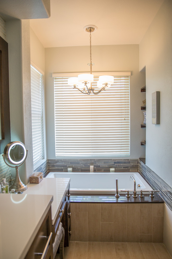 Large trendy master gray tile light wood floor bathroom photo in San Diego with an integrated sink, beaded inset cabinets, dark wood cabinets, limestone countertops, a one-piece toilet and gray walls