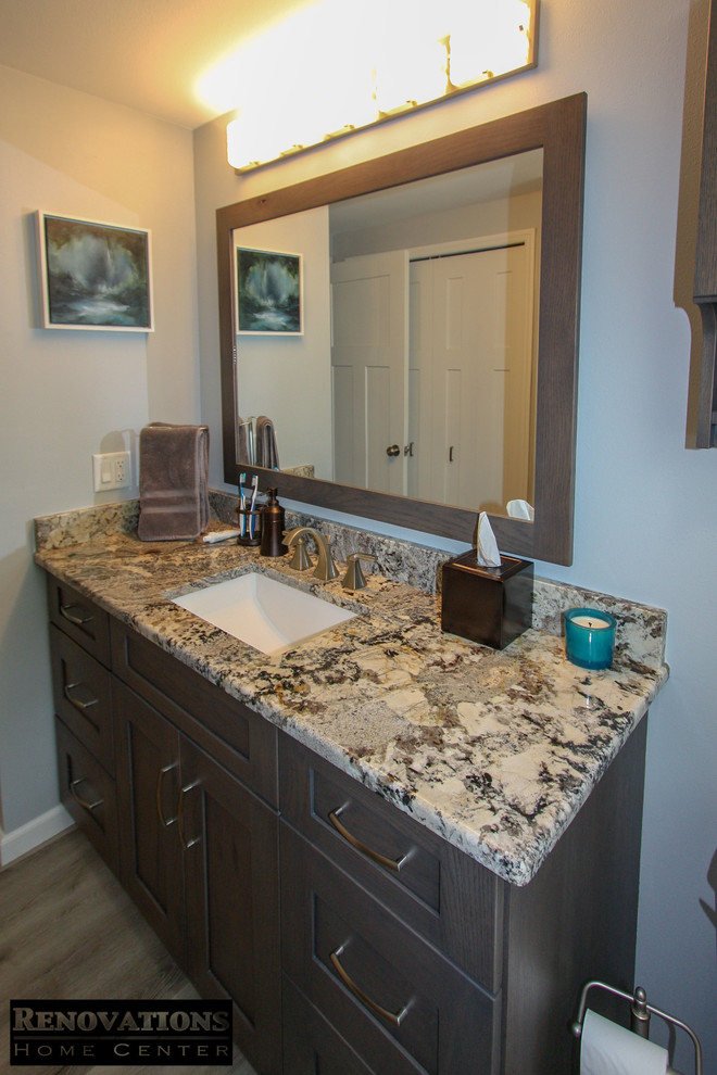 Design ideas for a medium sized rustic bathroom in Tampa with shaker cabinets, brown cabinets, an alcove shower, multi-coloured tiles, ceramic tiles, vinyl flooring, a submerged sink, granite worktops, brown floors and multi-coloured worktops.