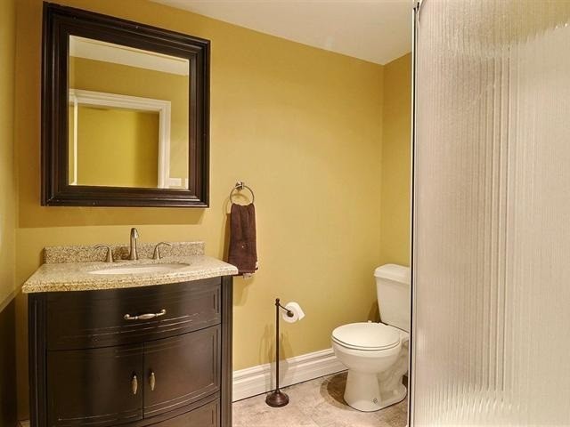 Photo of a medium sized contemporary bathroom in Montreal with a one-piece toilet, ceramic tiles, an integrated sink, beaded cabinets, a corner shower, granite worktops, dark wood cabinets, a corner bath, beige tiles, yellow walls and ceramic flooring.
