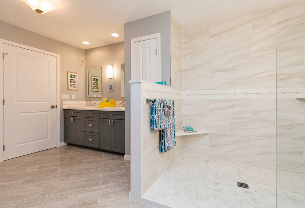 Inspiration for a large modern master white tile and marble tile slate floor and beige floor bathroom remodel in Other with recessed-panel cabinets, gray cabinets, a one-piece toilet, gray walls, a drop-in sink and quartzite countertops