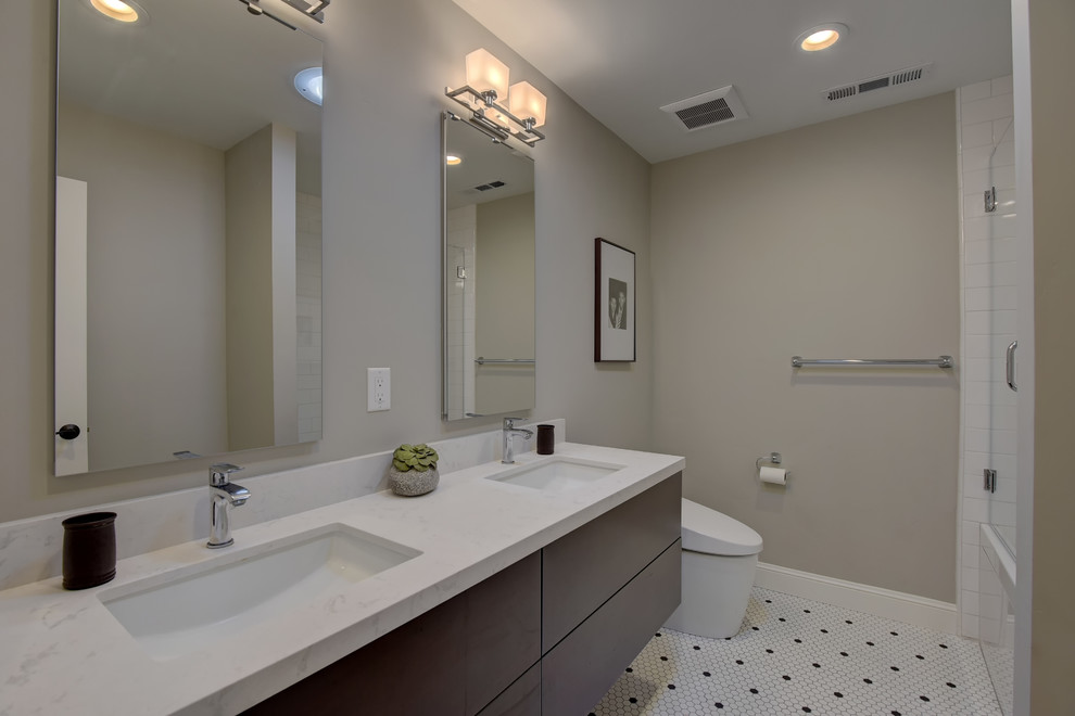 Photo of a medium sized contemporary family bathroom in San Francisco with flat-panel cabinets, dark wood cabinets, a submerged sink, marble worktops, white floors, a hinged door, a built-in bath, a one-piece toilet, white tiles, ceramic tiles, mosaic tile flooring, a shower/bath combination and blue walls.