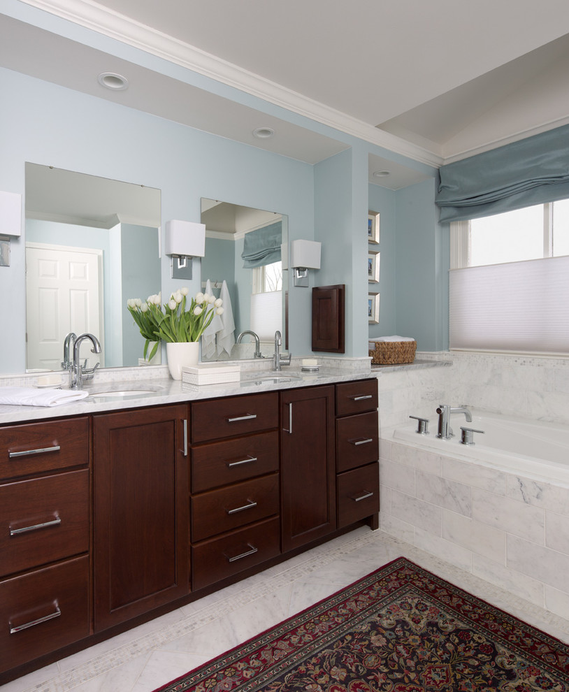 Inspiration for a large timeless master marble floor and gray floor drop-in bathtub remodel in Detroit with recessed-panel cabinets, dark wood cabinets, blue walls and an undermount sink