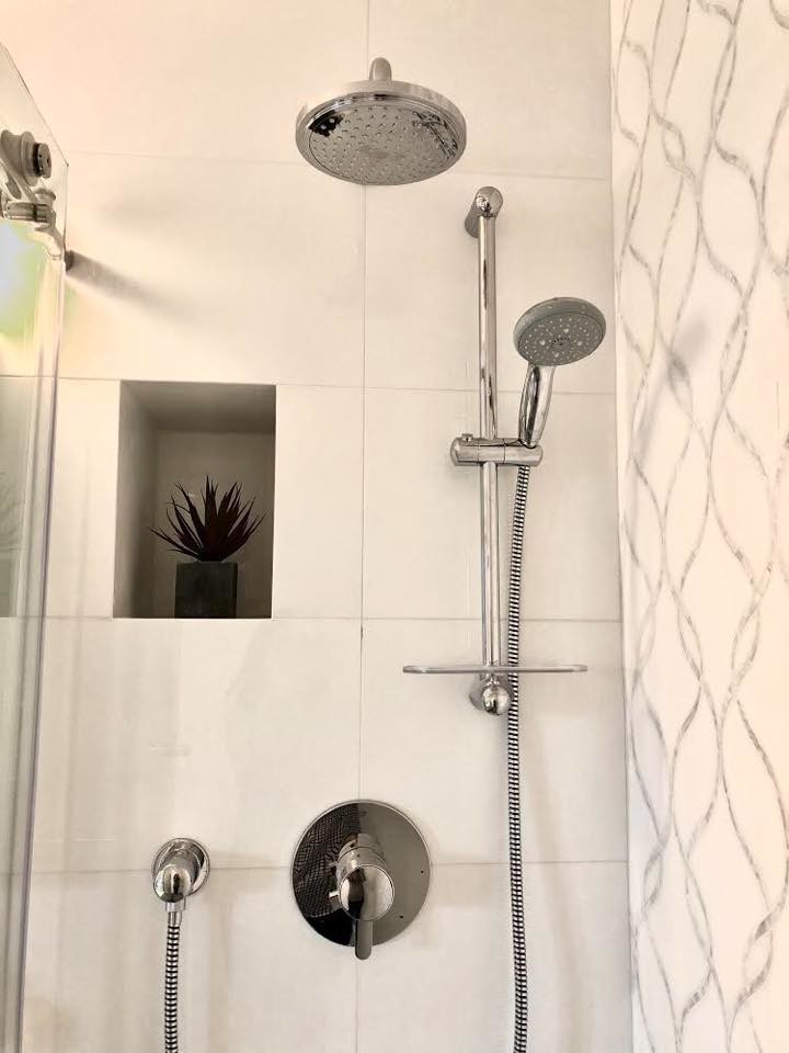 Photo of a small modern shower room bathroom in New York with flat-panel cabinets, white cabinets, an alcove shower, a two-piece toilet, white tiles, porcelain tiles, white walls, an integrated sink, engineered stone worktops, a sliding door and white worktops.
