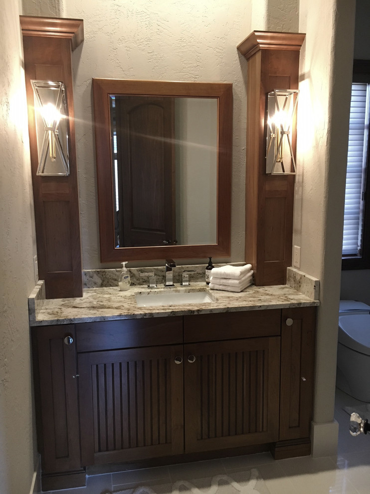 This is an example of a medium sized classic shower room bathroom in Other with beaded cabinets, medium wood cabinets, a one-piece toilet, beige walls, ceramic flooring, a submerged sink, granite worktops and white floors.