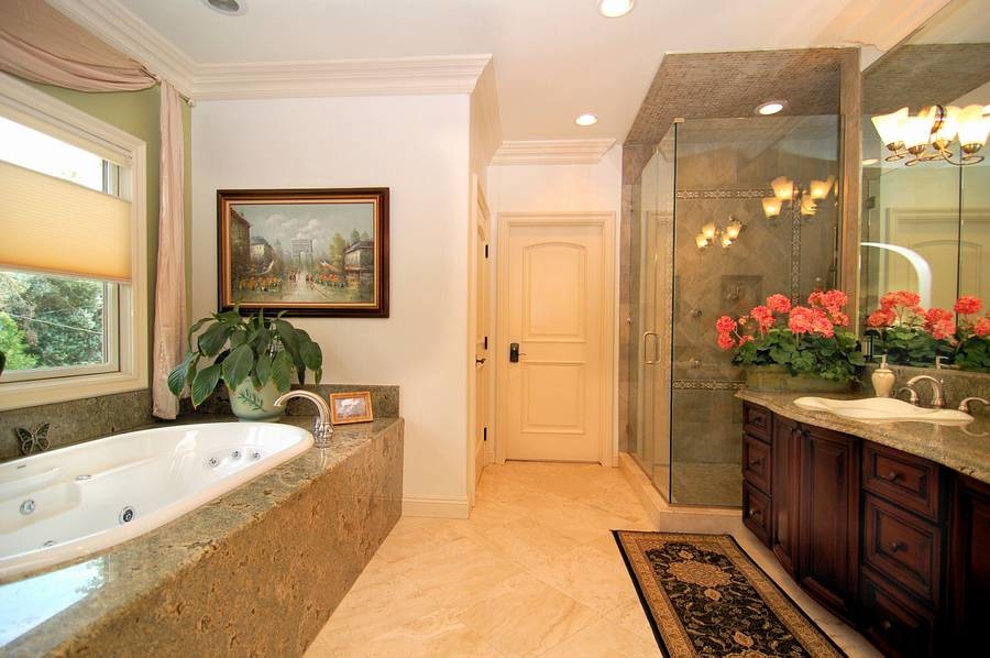 Large elegant master gray tile and stone tile porcelain tile and beige floor bathroom photo in Los Angeles with a drop-in sink, beaded inset cabinets, dark wood cabinets, white walls, granite countertops and a hinged shower door