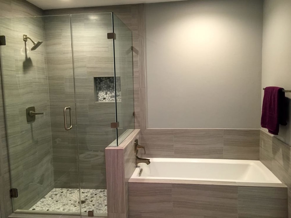Example of a mid-sized transitional master beige tile and porcelain tile bathroom design in Orange County with gray walls and a hinged shower door