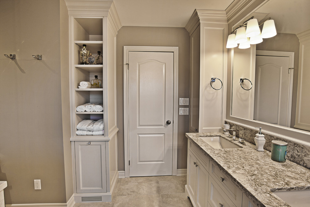 Mid-sized transitional master beige tile and porcelain tile porcelain tile bathroom photo in Toronto with furniture-like cabinets, white cabinets, a one-piece toilet, brown walls, an undermount sink and quartzite countertops