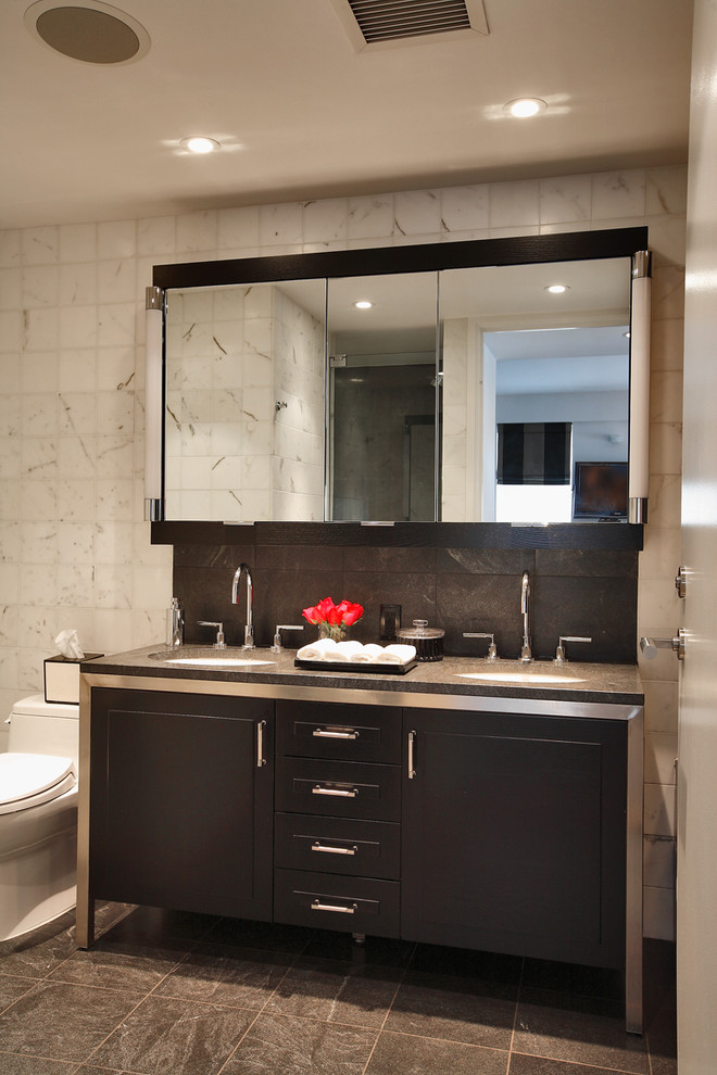 Photo of a modern bathroom in New York with black cabinets.