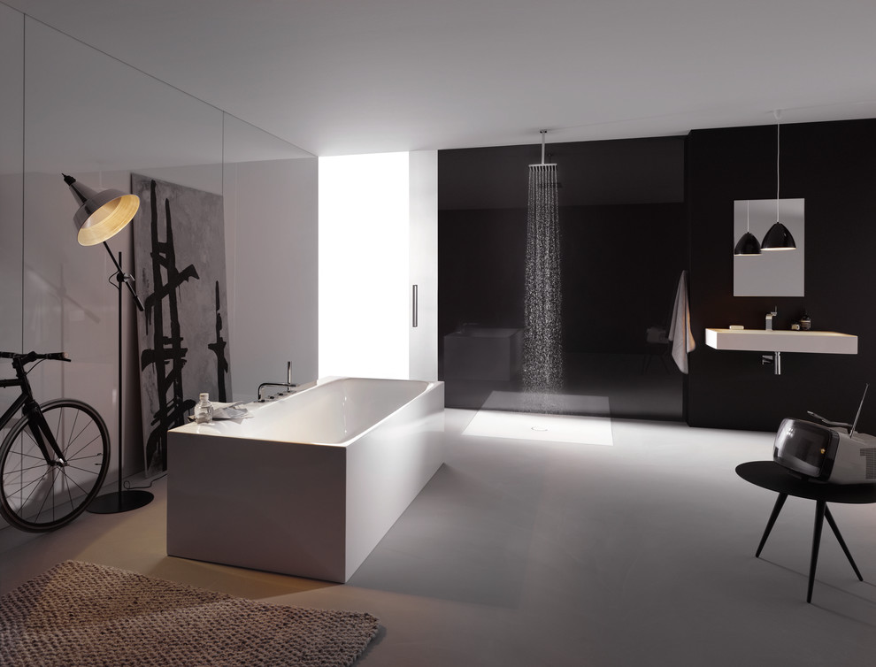 Design ideas for a large contemporary family bathroom in London with a wall-mounted sink, a freestanding bath, a walk-in shower, grey tiles and black walls.
