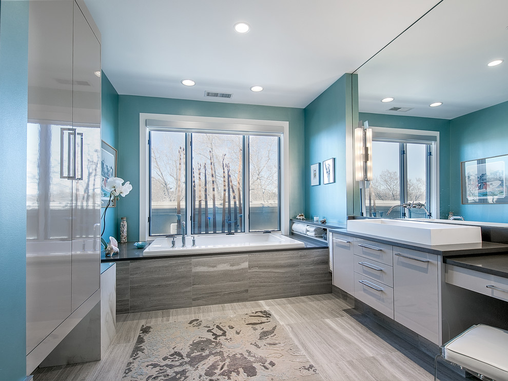 Example of a trendy gray tile drop-in bathtub design in Denver with a vessel sink, flat-panel cabinets and gray cabinets