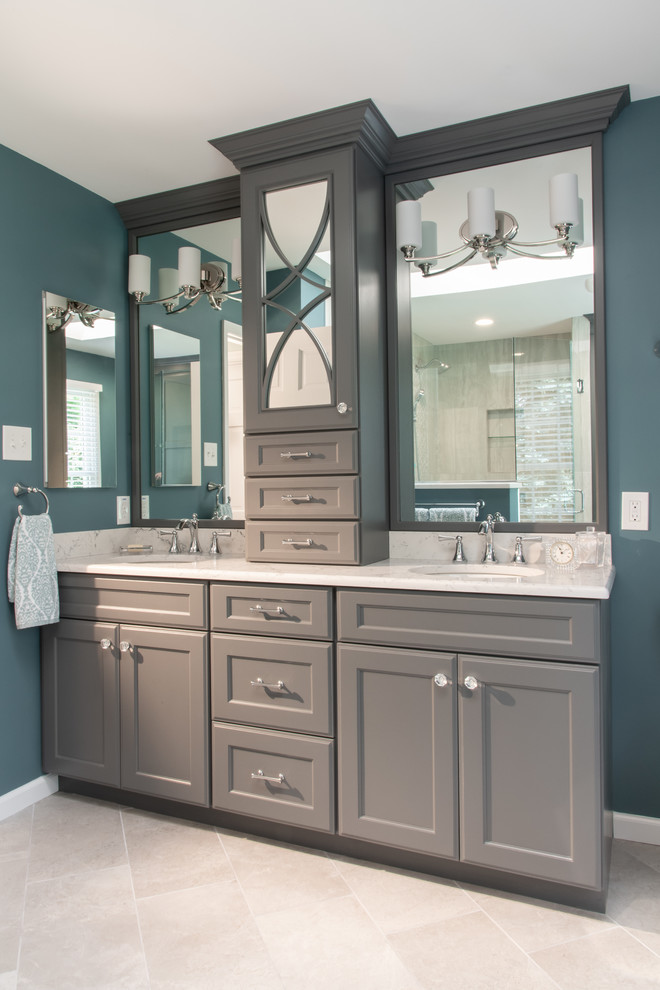 Example of a large classic master gray tile and porcelain tile porcelain tile and gray floor corner shower design in St Louis with shaker cabinets, gray cabinets, blue walls, an undermount sink, quartz countertops, a hinged shower door and white countertops