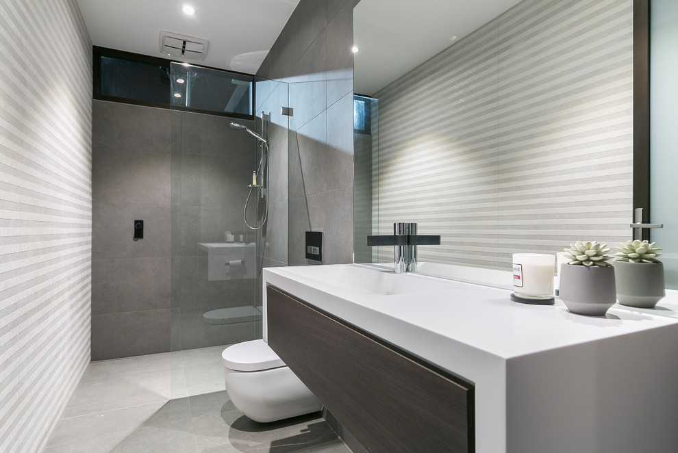 Bathroom - small modern master gray tile and ceramic tile porcelain tile and gray floor bathroom idea in Adelaide with furniture-like cabinets, dark wood cabinets, white walls, a drop-in sink, concrete countertops and gray countertops