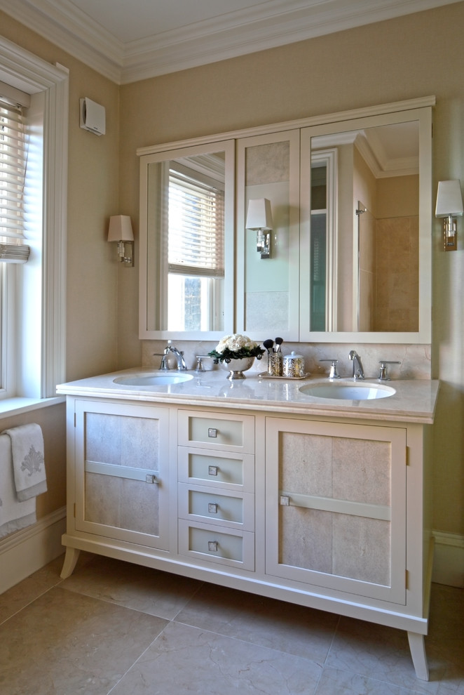 Classic bathroom in London with a submerged sink, beige cabinets, beige tiles and beige walls.