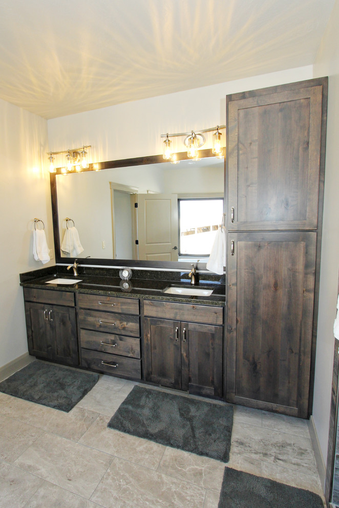 Example of a large classic ceramic tile bathroom design in Other with recessed-panel cabinets, dark wood cabinets, granite countertops and green countertops
