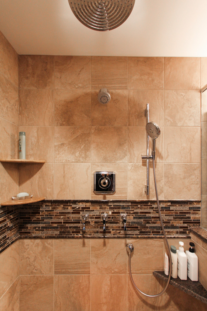 Example of a large transitional master beige tile and porcelain tile porcelain tile and beige floor corner shower design in Philadelphia with shaker cabinets, dark wood cabinets, a two-piece toilet, beige walls, an undermount sink, granite countertops, a hinged shower door and brown countertops