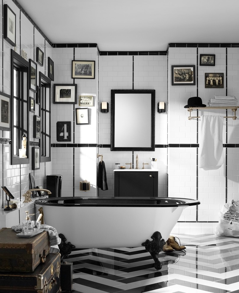 This is an example of a medium sized bohemian ensuite bathroom in Philadelphia with flat-panel cabinets, black cabinets, a claw-foot bath, black and white tiles, metro tiles, white walls, porcelain flooring, an integrated sink and multi-coloured floors.