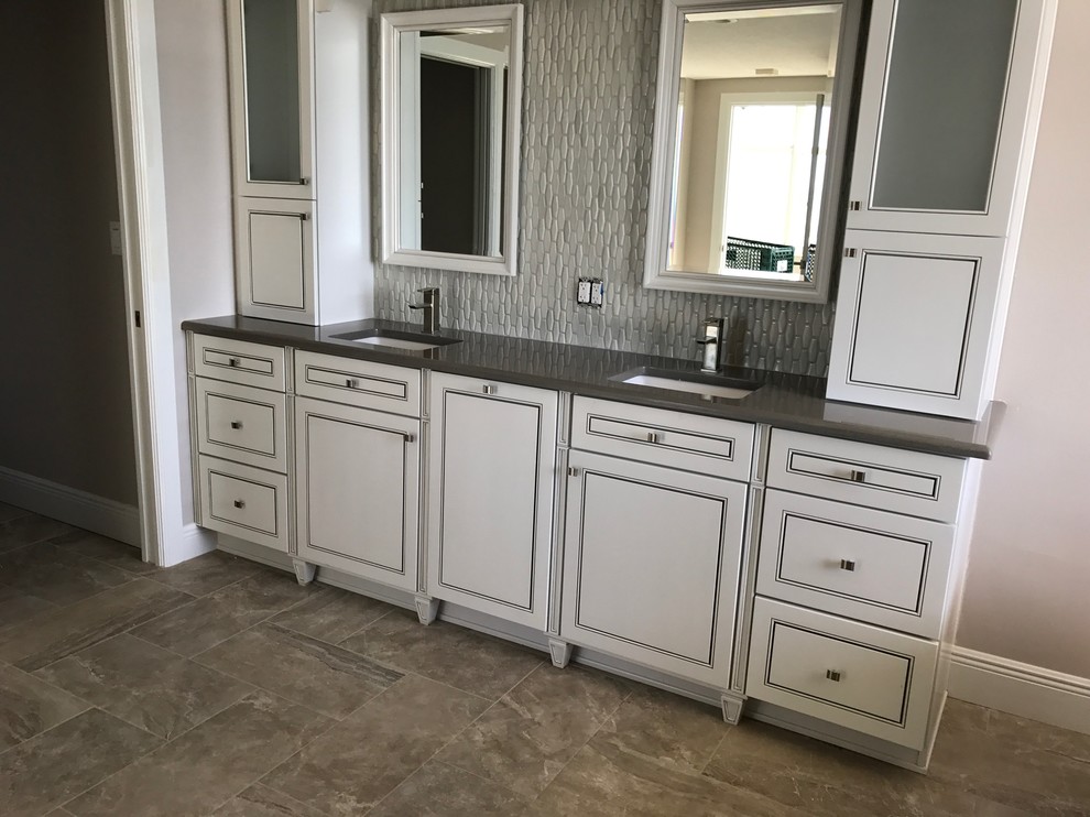 Inspiration for a medium sized classic ensuite bathroom in Tampa with raised-panel cabinets, white cabinets, a freestanding bath, a walk-in shower, a two-piece toilet, white tiles, ceramic tiles, beige walls, ceramic flooring, a submerged sink, engineered stone worktops, beige floors and a hinged door.