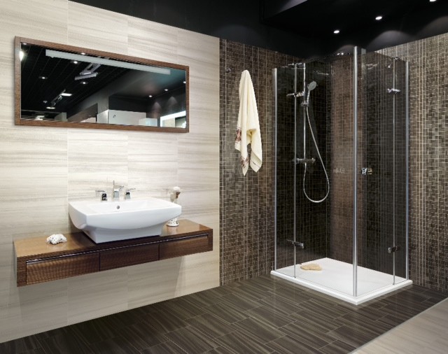 На фото: ванная комната в современном стиле с фасадами цвета дерева среднего тона, угловым душем, коричневой плиткой, керамогранитной плиткой, серыми стенами и полом из керамогранита с