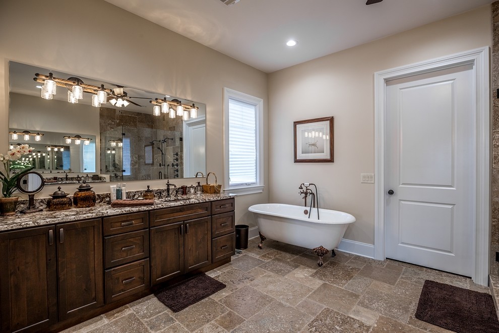 Photo of a traditional ensuite bathroom in Other with shaker cabinets, distressed cabinets, a claw-foot bath, a corner shower, beige walls, ceramic flooring, a submerged sink, granite worktops, beige floors and a hinged door.