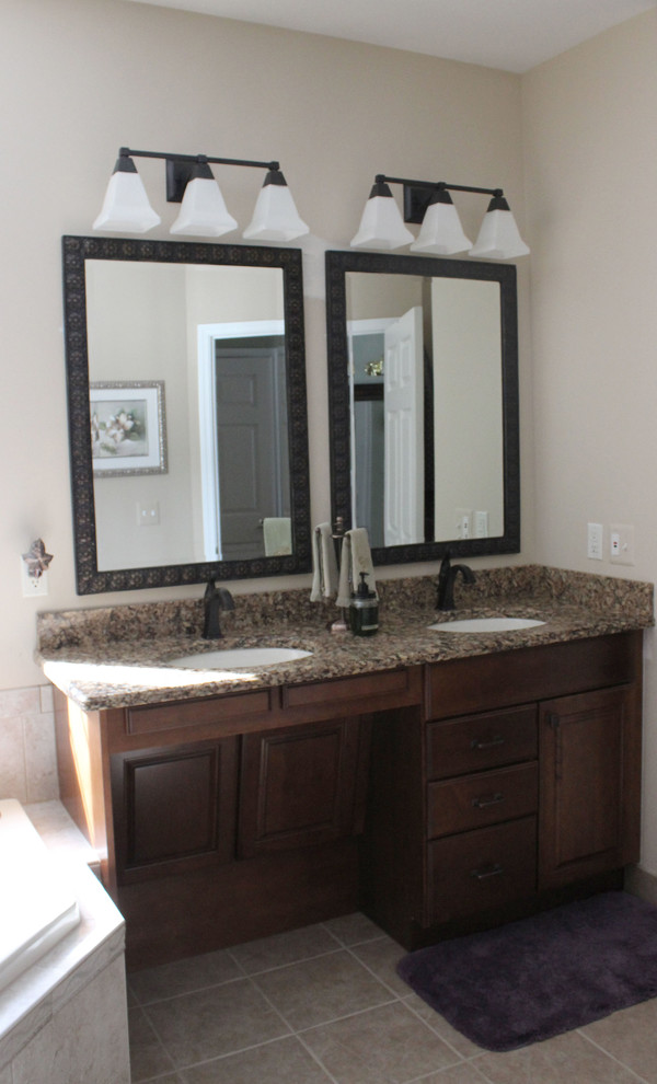 Photo of a large classic ensuite bathroom in Other with raised-panel cabinets, medium wood cabinets, a corner shower, beige walls and ceramic flooring.